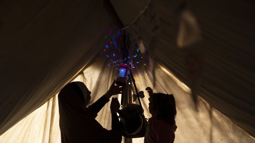 A Gaza family uprooted by war and grieving their losses shares a somber Ramadan meal in a tent